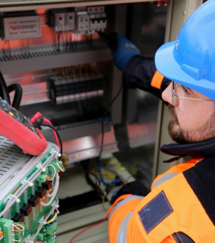 Man adjusting circuit breakers