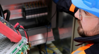 Man adjusting circuit breakers