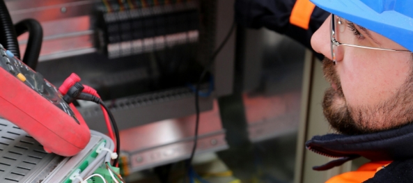 Man adjusting circuit breakers